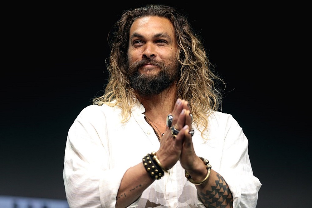 Jason Momoa (01/08/1979) ficou muito conhecido por seu papel como "Aquaman" (2018) no Universo Cinematográfico da DC. Além disso, estrelou "Game of Thrones" (2011-2012) como Khal Drogo. Seu carisma e físico imponente o tornaram um dos ícones de ação da atualidade.