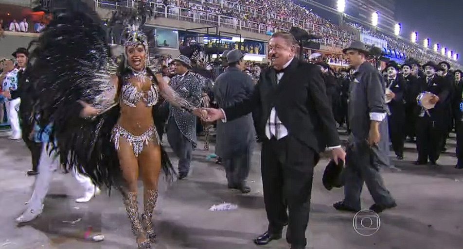Beija-Flor de Nilópolis 2014 - Boni - A Azul e Branco homenageou o ex-diretor geral da TV Globo, que marcou ao comandar a emissora no auge do veículo de comunicação. Ele esteve ao lado da então rainha de bateria Raíssa de Oliveira. A agremiação ficou com o sétimo lugar, fora das campeãs. 