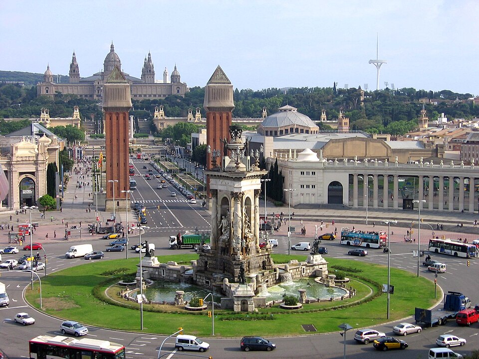 Barcelona também tem a sua Plaza d'Espanya, com grafia diferente porque fica  na Catalunha, onde o povo se identifica com o idioma catalão  (Espanya em vez de España). A praça ocupa uma área de 32 mil m² e fica no cruzamento de importantes vias da cidade, com um chafariz no centro e as imponentes Torres Venezianas. Ao fundo, o Museu Nacional de Arte da Catalunha.-Canaan - wikimedia commons