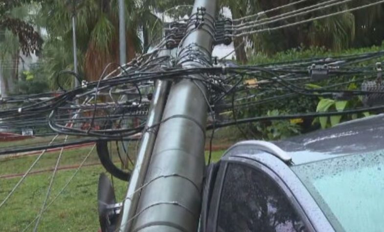 Poste com cabos elétricos cai sobre carro