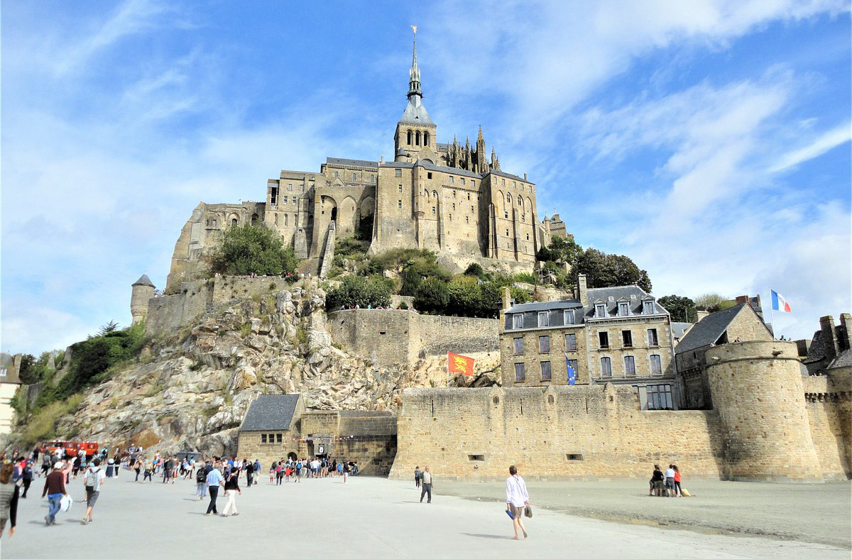 A transformação em ilha ocorre quando as águas do Canal da Mancha cercam completamente o monte. Este fenômeno ocorre devido às grandes amplitudes das marés na região, que ultrapassa 14 metros. Durante a maré baixa, é possível caminhar até o monte pela areia. Mas atenção: é perigoso sem guia, pois a maré sobe rapidamente.