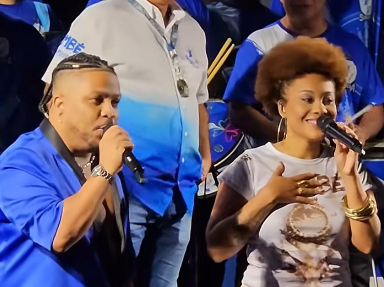 <p>Nino do Milênio e Jessica Martin – Dupla escolhida na final do reality ‘A Voz do Carnaval’ para substituir Neguinho, ícone absoluto da Beija-Flor e que se aposentou. Com estilos complementares, eles têm a missão de serem os intérpretes de “Bembé do Mercado”.</p>
