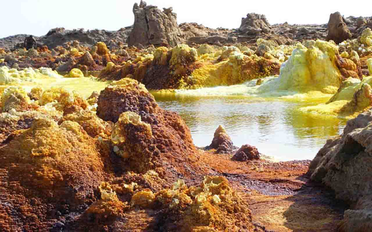 Sob a superfície, há um manto de sal com dois quilômetros de espessura, resultado das invasões do Mar Vermelho nos últimos 200 mil anos. Esse depósito resiste ao magma que tenta emergir, mas acaba se rompendo, liberando líquidos e gases que transformam a paisagem em um espetáculo mineral efêmero.
