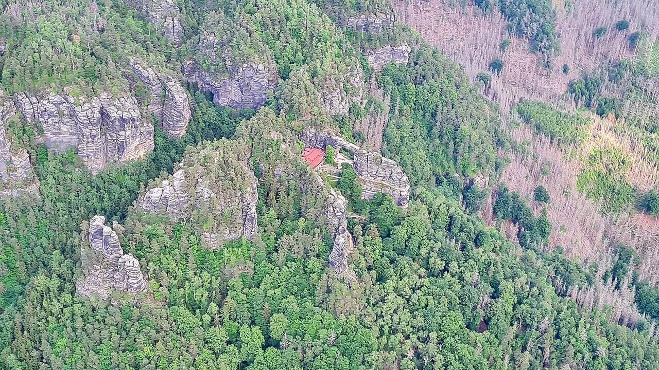 Situado no Parque Nacional da Suíça Boêmia, próximo à fronteira com a Alemanha, o arco é acessível por trilhas que atravessam florestas densas e paisagens rochosas. A caminhada até o monumento é considerada uma experiência enriquecedora, pois combina esforço físico moderado com vistas espetaculares da região. O acesso controlado busca preservar o ambiente natural, garantindo que visitantes possam admirar o arco sem comprometer sua integridade ecológica.